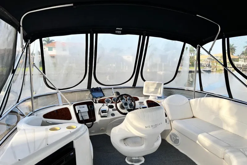 Slide: The Image of 2004 Meridian 459 Motoryacht helm with modern navigation equipment and luxurious seating. - 10