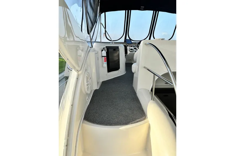 Slide: The Image of 2004 Meridian 459 Motoryacht interior with carpeted walkway and modern helm. - 7
