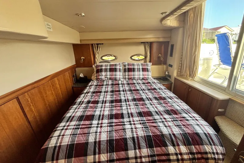 Slide: The Image of Luxurious cabin interior of 2004 Meridian 459 Motoryacht with plaid bedding. - 29