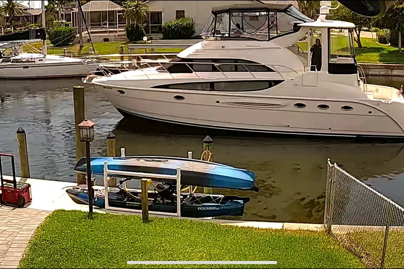 Slide: The Image of 2004 Meridian 459 Motoryacht docked in a sunny marina setting. - 38