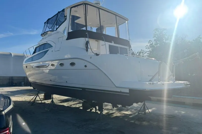 Slide: The Image of 2004 Meridian 459 Motoryacht on stands, sunlit, with clear blue sky background. - 46