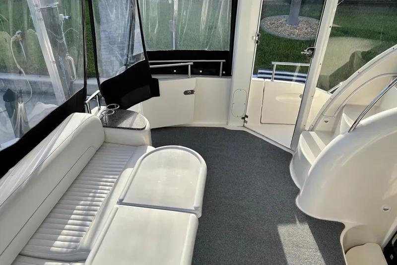 Slide: The Image of 2004 Meridian 459 Motoryacht interior with white seating and carpeted floor. - 15