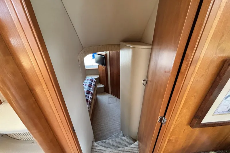 Slide: The Image of Interior view of 2004 Meridian 459 Motoryacht cabin with wood paneling and cozy bed. - 33