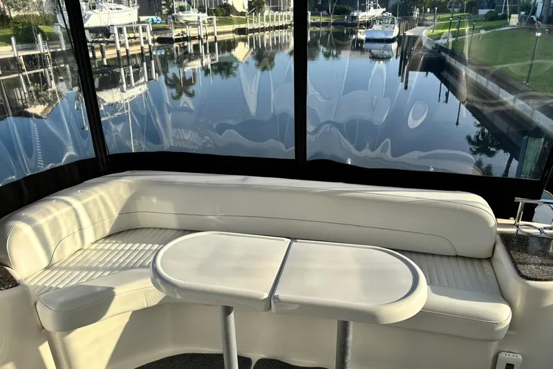 Slide: The Image of Luxurious seating area on a 2004 Meridian 459 Motoryacht with scenic marina view. - 14