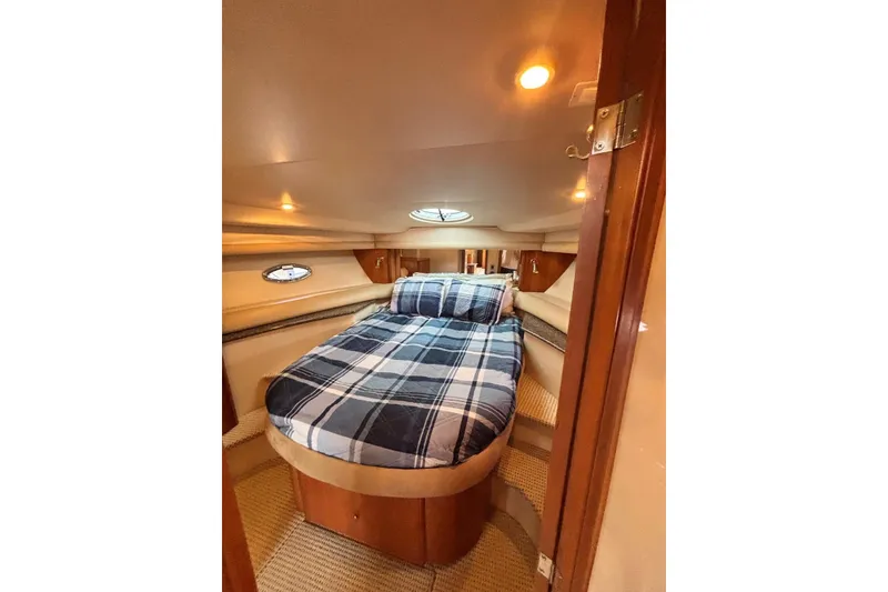 Slide: The Image of Cozy bedroom interior of 2004 Meridian 459 Motoryacht with plaid bedding and warm lighting. - 21
