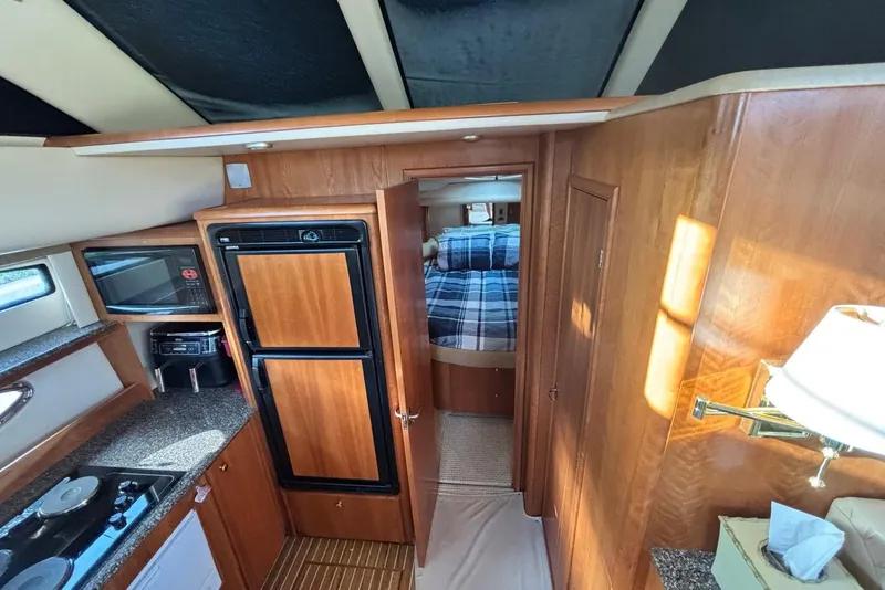 Slide: The Image of Interior of 2004 Meridian 459 Motoryacht with kitchen and cozy bedroom. - 24