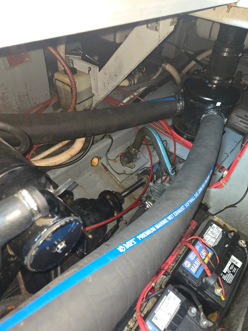 Slide: The Image of The engine compartment of a 1987 Sea Ray 300 Weekender with hoses, cables, and batteries. - 22