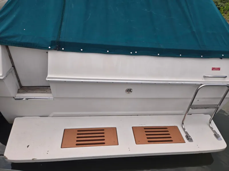 Slide: The Image of The image shows the stern of a 1987 Sea Ray 300 Weekender with a swim platform and ladder. - 2