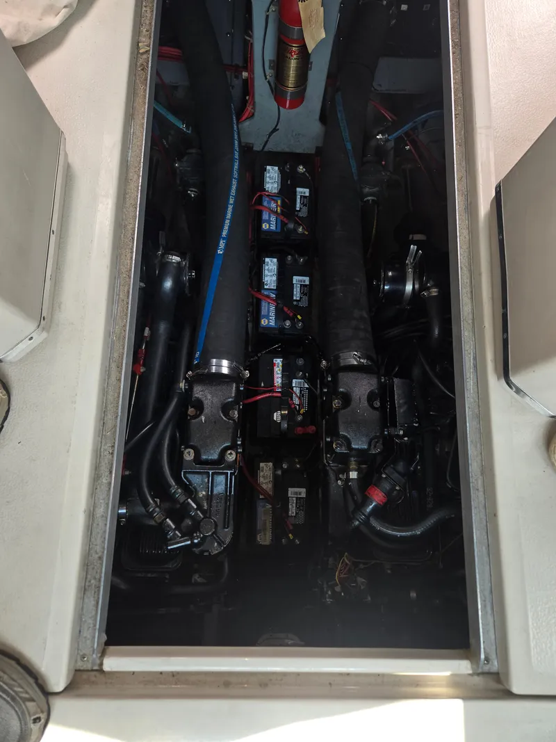 Slide: The Image of The engine compartment of a 1987 Sea Ray 300 Weekender with visible engines and batteries. - 19