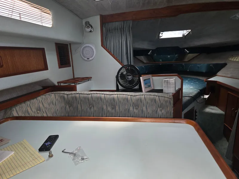 Slide: The Image of Interior of a 1987 Sea Ray 300 Weekender with seating area and sleeping quarters. - 11