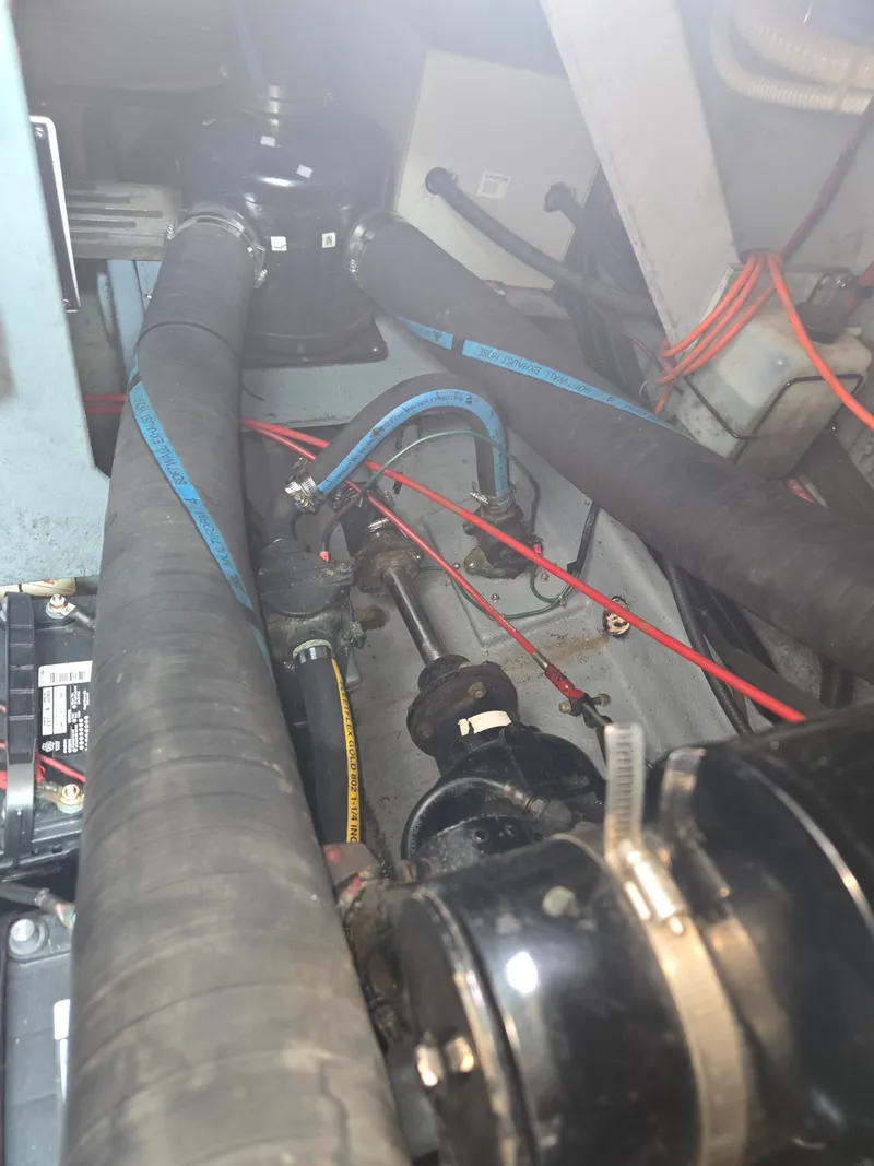 Slide: The Image of The engine compartment of a 1987 Sea Ray 300 Weekender with hoses and cables. - 23
