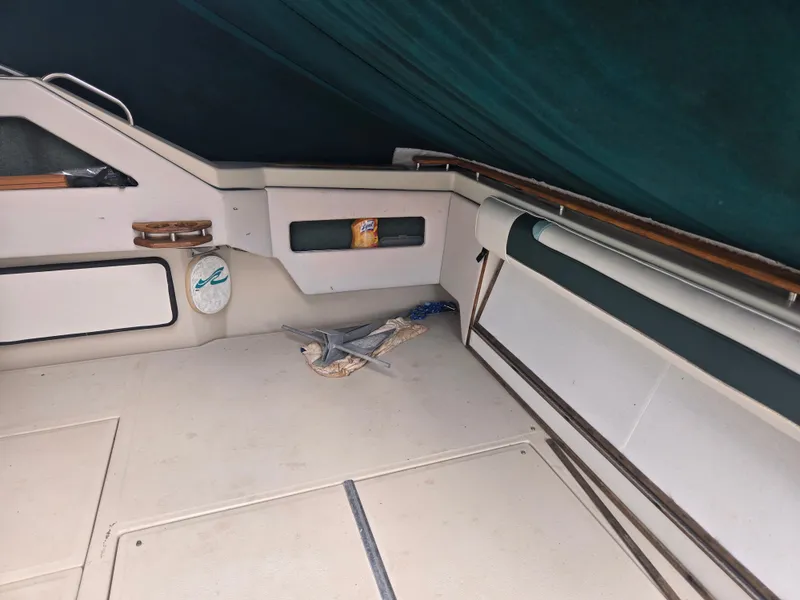 Slide: The Image of The image shows the cockpit of a 1987 Sea Ray 300 Weekender with an anchor and ropes. - 7