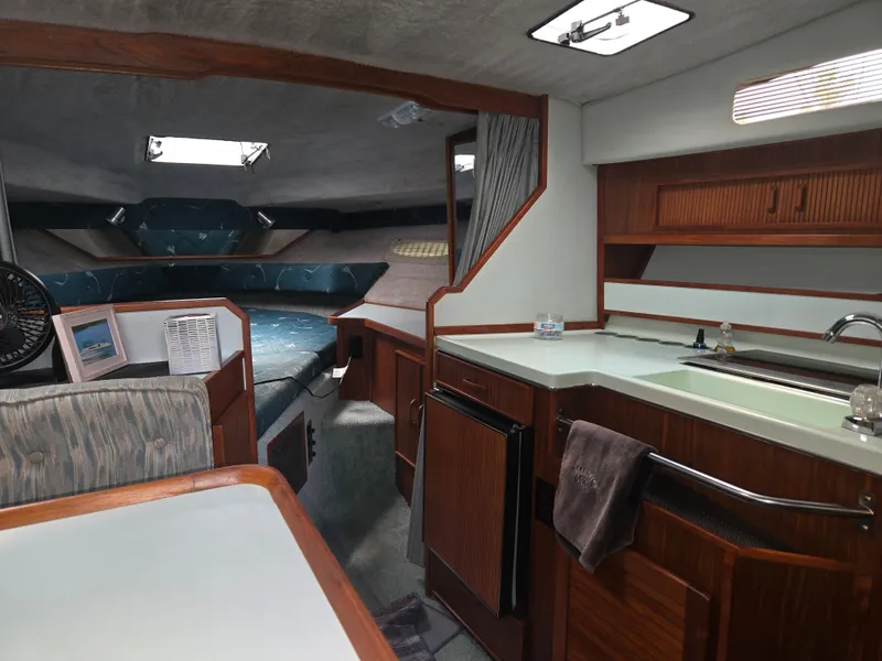 Slide: The Image of Interior of a 1987 Sea Ray 300 Weekender featuring a galley and sleeping area. - 10