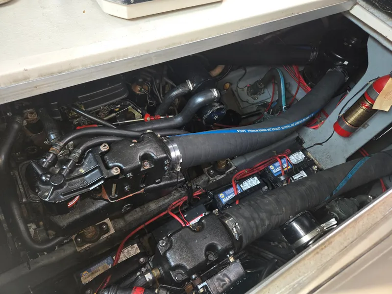 Slide: The Image of The engine compartment of a 1987 Sea Ray 300 Weekender with visible engines and wiring. - 21