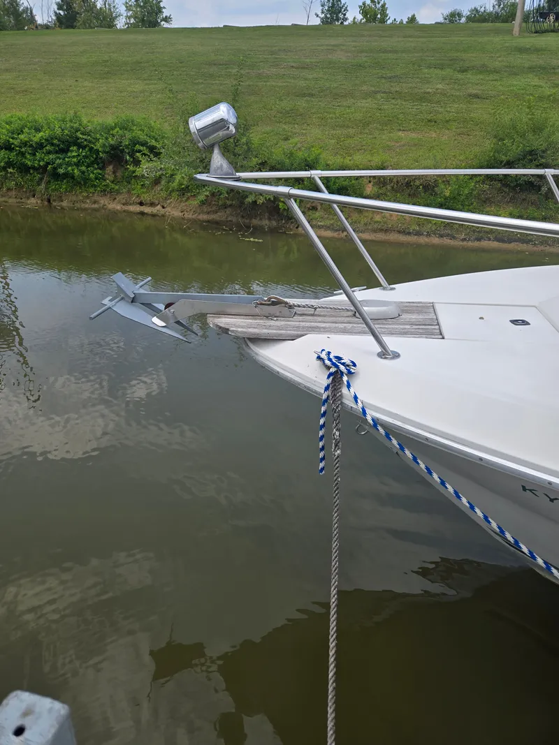 Slide: The Image of A 1987 Sea Ray 300 Weekender is docked by the edge of a calm waterway. - 5