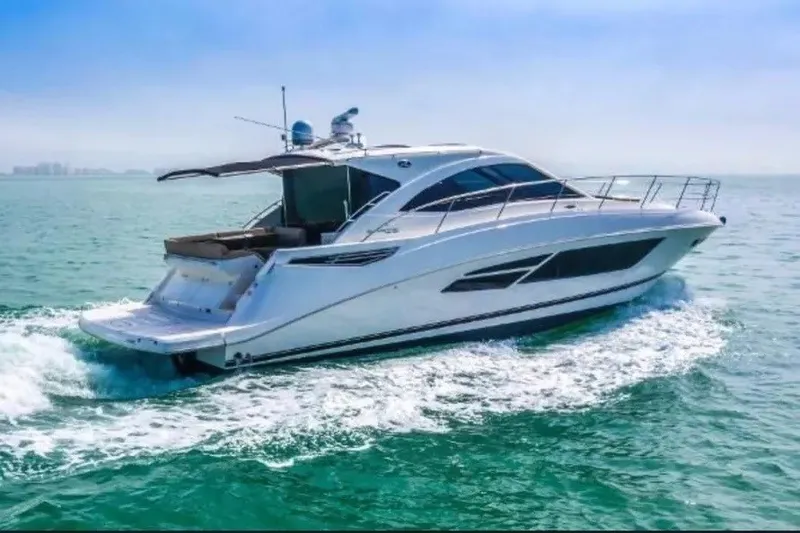 Slide: The Image of 2016 Sea Ray Sundancer 510 yacht cruising on open water under clear skies. - 2