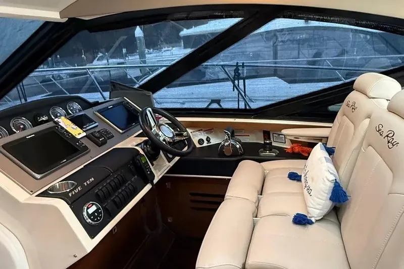 Slide: The Image of 2016 Sea Ray Sundancer 510 helm with luxurious seating and advanced navigation controls. - 10