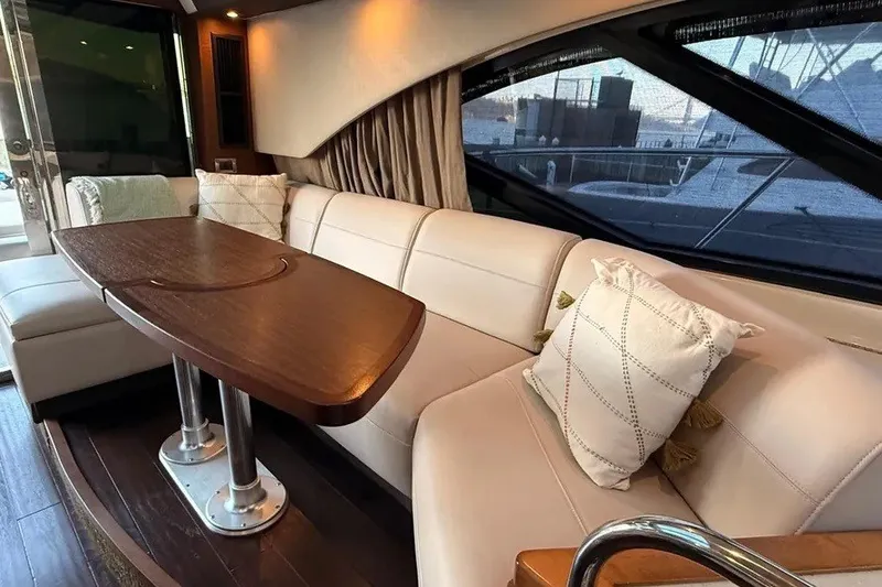 Slide: The Image of Luxurious interior of 2016 Sea Ray Sundancer 510 yacht with elegant seating and wooden table. - 17