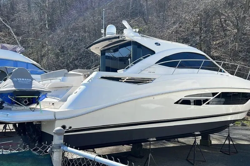 Slide: The Image of 2016 Sea Ray Sundancer 510 yacht on stands, with Yamaha equipment nearby. - 5
