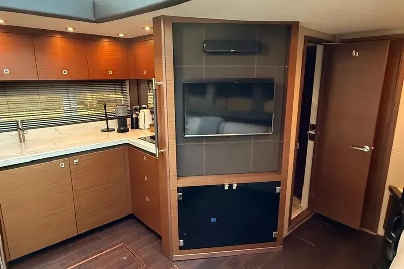 Slide: The Image of Luxurious interior of 2016 Sea Ray Sundancer 510 yacht with modern kitchen and entertainment area. - 14