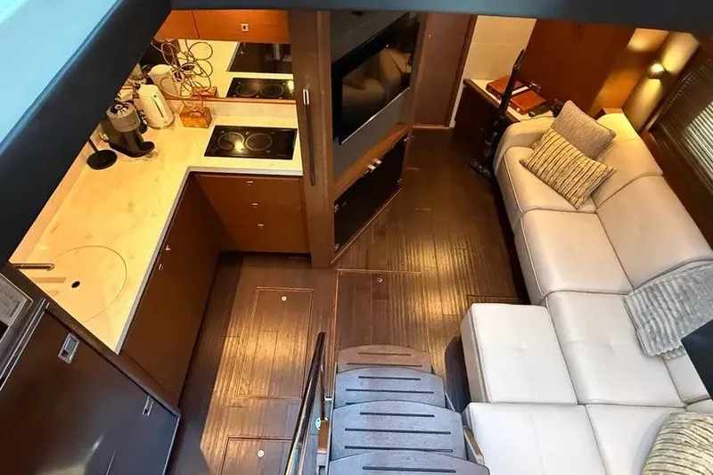 Slide: The Image of Luxurious interior of 2016 Sea Ray Sundancer 510 yacht with modern kitchen and cozy seating area. - 15