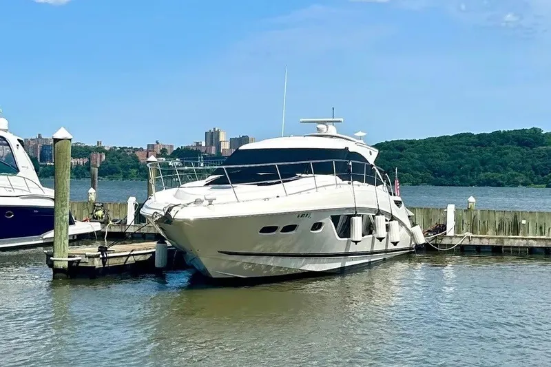 Slide: The Image of 2016 Sea Ray Sundancer 510 yacht docked at a marina with scenic background. - 7