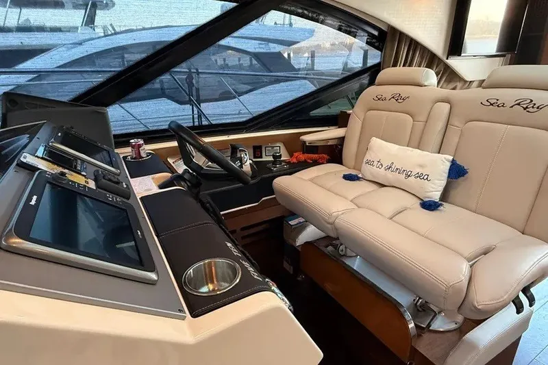 Slide: The Image of Luxurious 2016 Sea Ray Sundancer 510 yacht interior with plush seating and advanced navigation controls. - 9