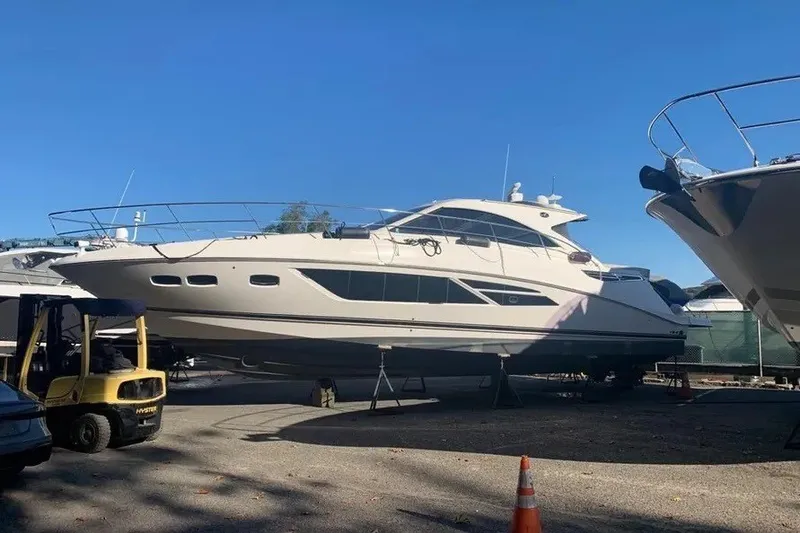 Slide: The Image of 2016 Sea Ray Sundancer 510 yacht on dry dock under clear blue sky. - 3