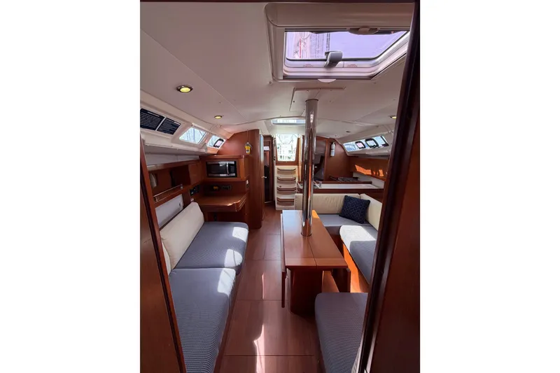 Slide: The Image of Interior of 2013 Beneteau Oceanis 370 yacht, featuring cozy seating and modern amenities. - 15