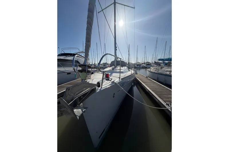 Slide: The Image of Beneteau Oceanis 370 sailboat docked in marina, 2013 model, under clear blue sky. - 5