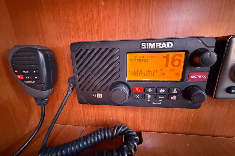 Slide: The Image of Simrad RS35 marine radio on Beneteau Oceanis 370, displaying distress signal on channel 16. - 24