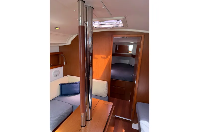Slide: The Image of Interior of 2013 Beneteau Oceanis 370 sailboat, featuring cozy seating and wooden finishes. - 35