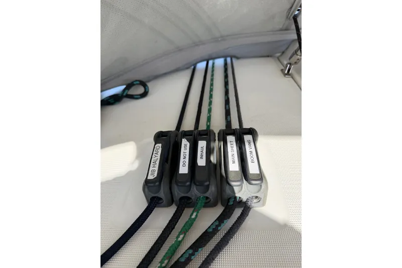 Slide: The Image of Close-up of labeled rope clutches on a 2013 Beneteau Oceanis 370 sailboat. - 20
