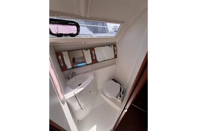 Slide: The Image of Beneteau Oceanis 370 bathroom interior, featuring sink, toilet, and mirror, 2013 model. - 36