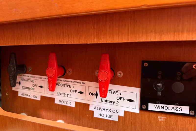 Slide: The Image of Control panel of a 2013 Beneteau Oceanis 370 sailboat with labeled switches. - 27