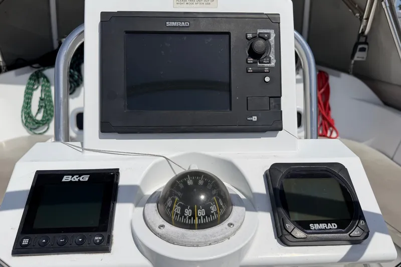Slide: The Image of Navigation instruments on a 2013 Beneteau Oceanis 370 sailboat, featuring Simrad and B&G displays. - 10