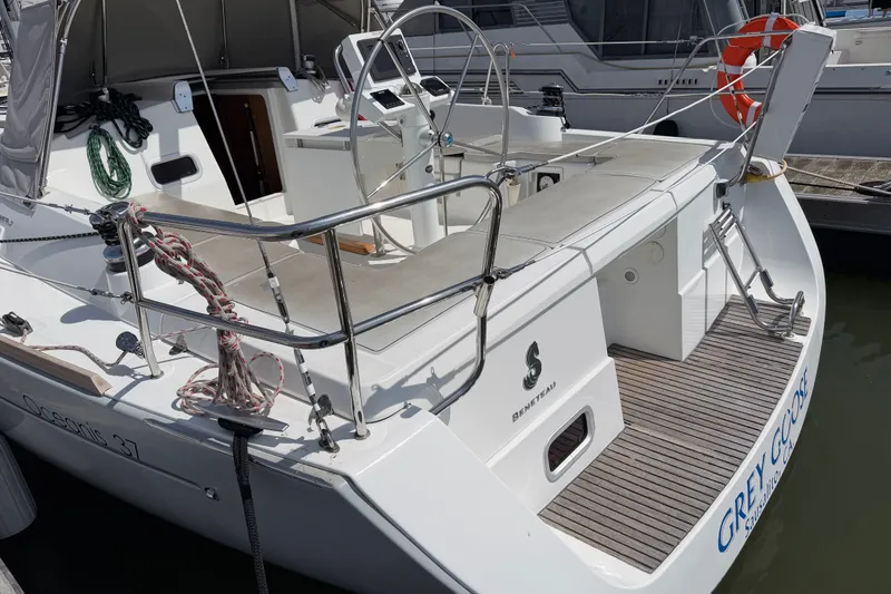 Slide: The Image of 2013 Beneteau Oceanis 370 sailboat with open cockpit and steering wheel, docked at marina. - 11