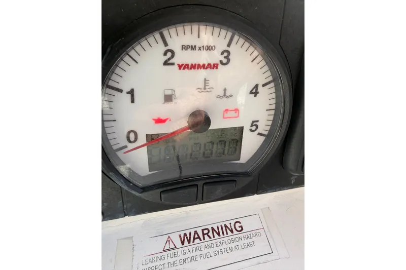 Slide: The Image of Yanmar RPM gauge on 2013 Beneteau Oceanis 370 sailboat, with warning label visible. - 38
