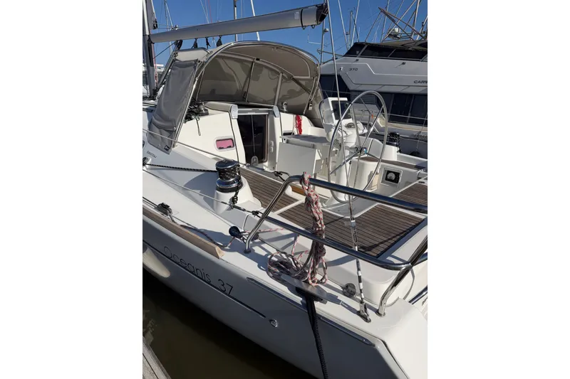 Slide: The Image of 2013 Beneteau Oceanis 370 sailboat docked, featuring sleek design and spacious deck. - 4