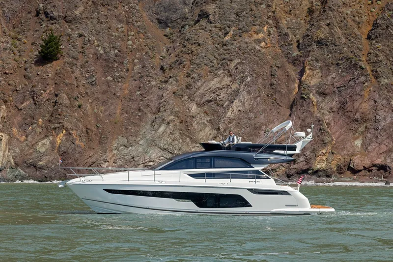 Slide: The Image of 2025 Fairline Squadron 50 yacht cruising near rocky coastline. - 37