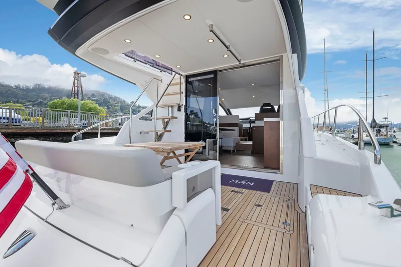 Slide: The Image of Luxury yacht Fairline Squadron 50, 2025 model, docked with open deck and modern interior. - 83