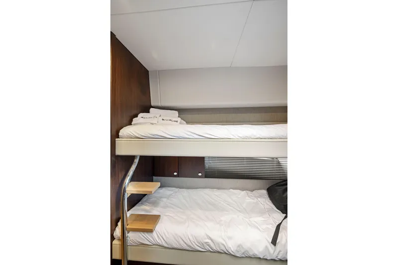 Slide: The Image of Bunk beds in 2025 Fairline Squadron 50 yacht cabin, featuring modern design and cozy bedding. - 67