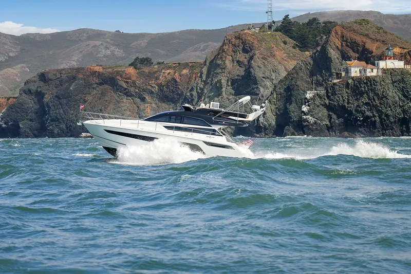 Slide: The Image of 2025 Fairline Squadron 50 yacht cruising near rocky coastline. - 21