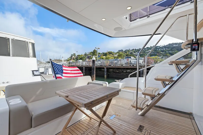 Slide: The Image of Luxury yacht Fairline Squadron 50, 2025 model, featuring elegant deck seating and American flag. - 91