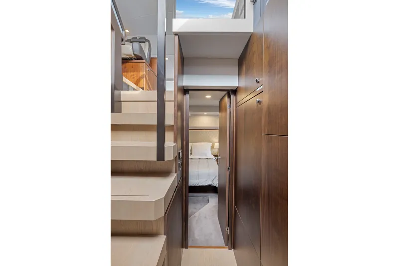Slide: The Image of Luxurious interior of 2025 Fairline Squadron 50 yacht, featuring elegant wood finishes and cozy bedroom. - 75