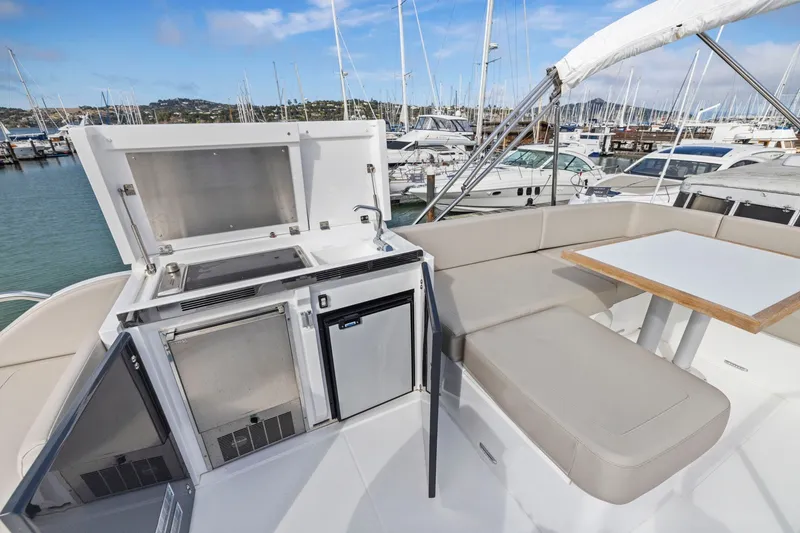 Slide: The Image of Luxury outdoor seating and kitchenette on 2025 Fairline Squadron 50 yacht. - 51