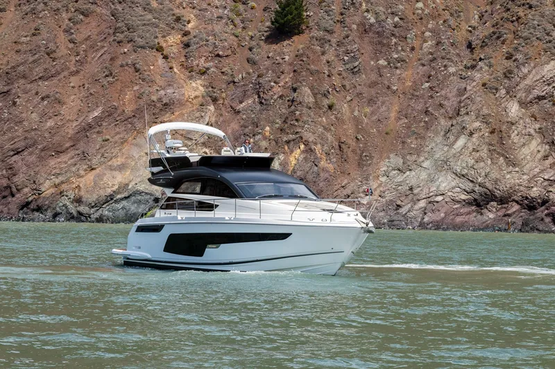 Slide: The Image of 2025 Fairline Squadron 50 yacht cruising near rocky coastline. - 40