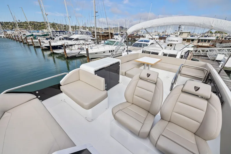 Slide: The Image of 2025 Fairline Squadron 50 yacht interior with luxurious seating at marina. - 97