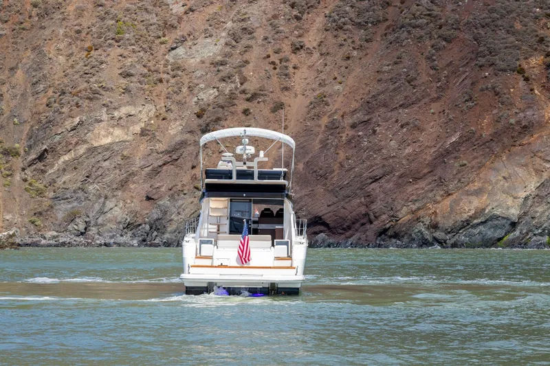 Slide: The Image of 2025 Fairline Squadron 50 yacht cruising near rocky coastline. - 42