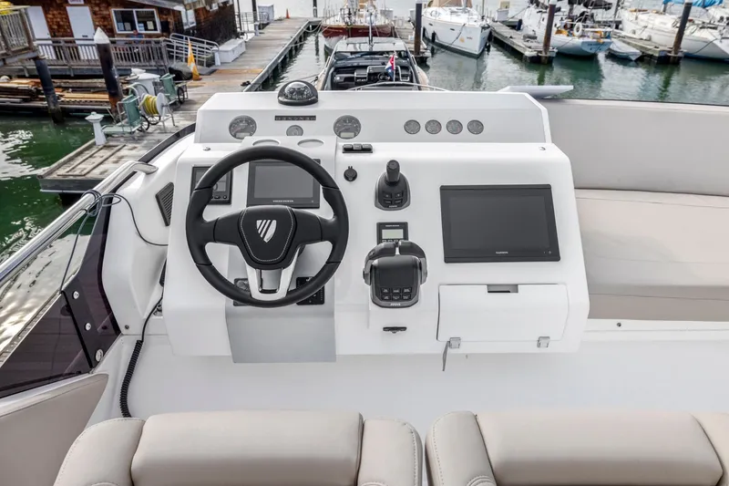 Slide: The Image of Cockpit of 2025 Fairline Squadron 50 yacht with modern navigation controls and steering wheel. - 53
